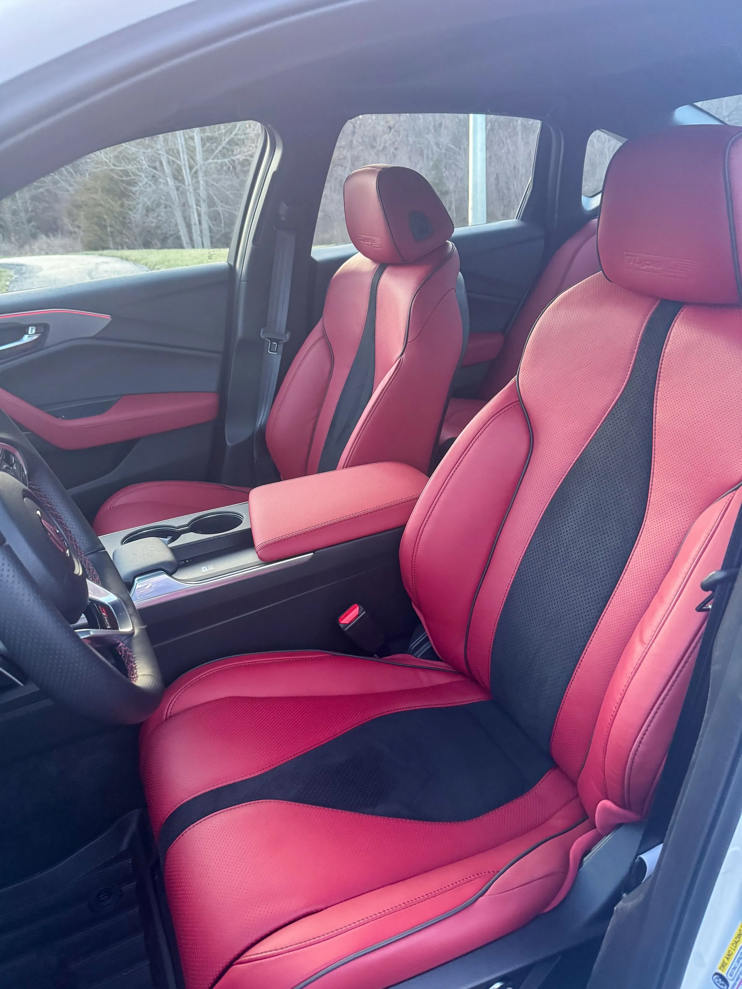 Front seats of an Acura TLX Type S in red and black leather, cleaned and conditioned
