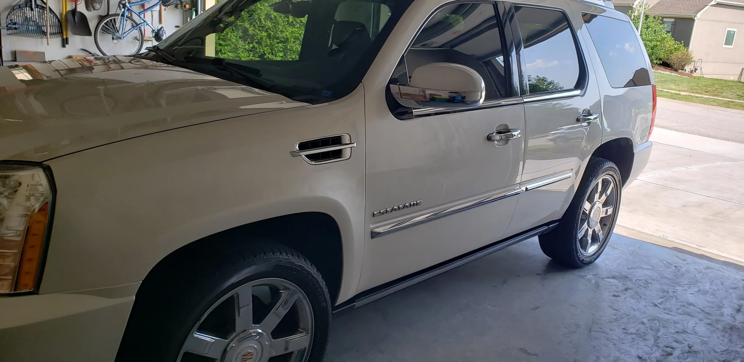 White Cadillac Escalade side profile after washing, chrome trim and wheels clean