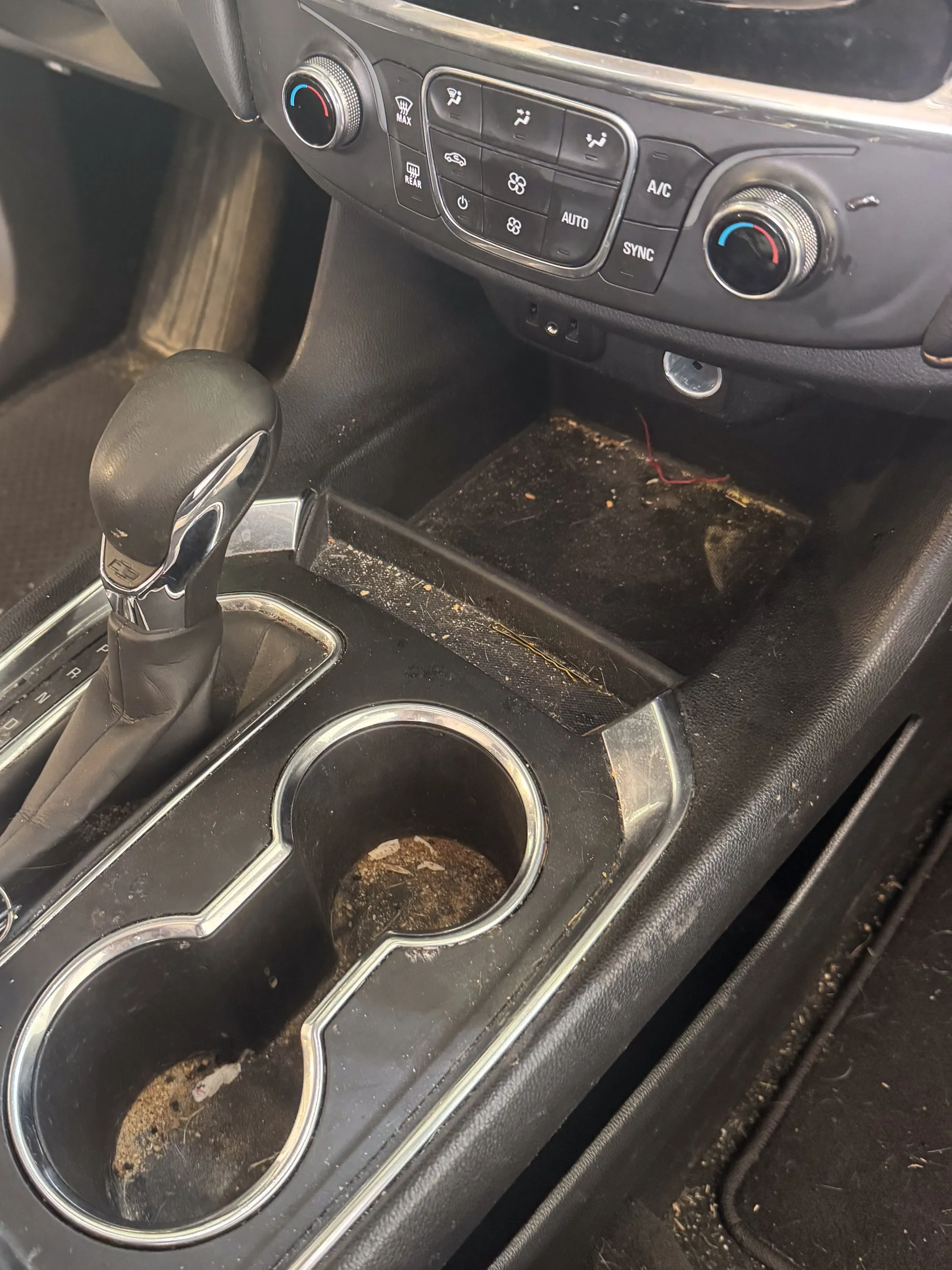 Before. Center console, ground-in dirt to factory clean
