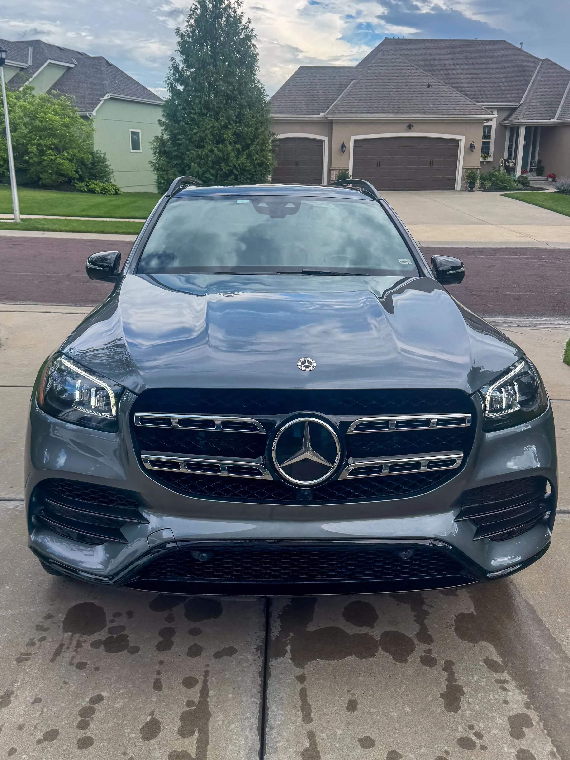 Grey Mercedes-Benz GLS photographed straight on in a driveway, grille and badge clean