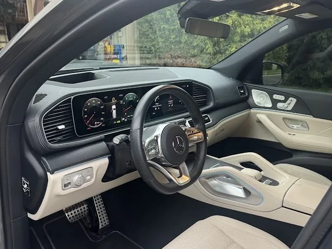 The cockpit of a Mercedes GLS after a premium interior detail, cream leather and dash clean and dressed