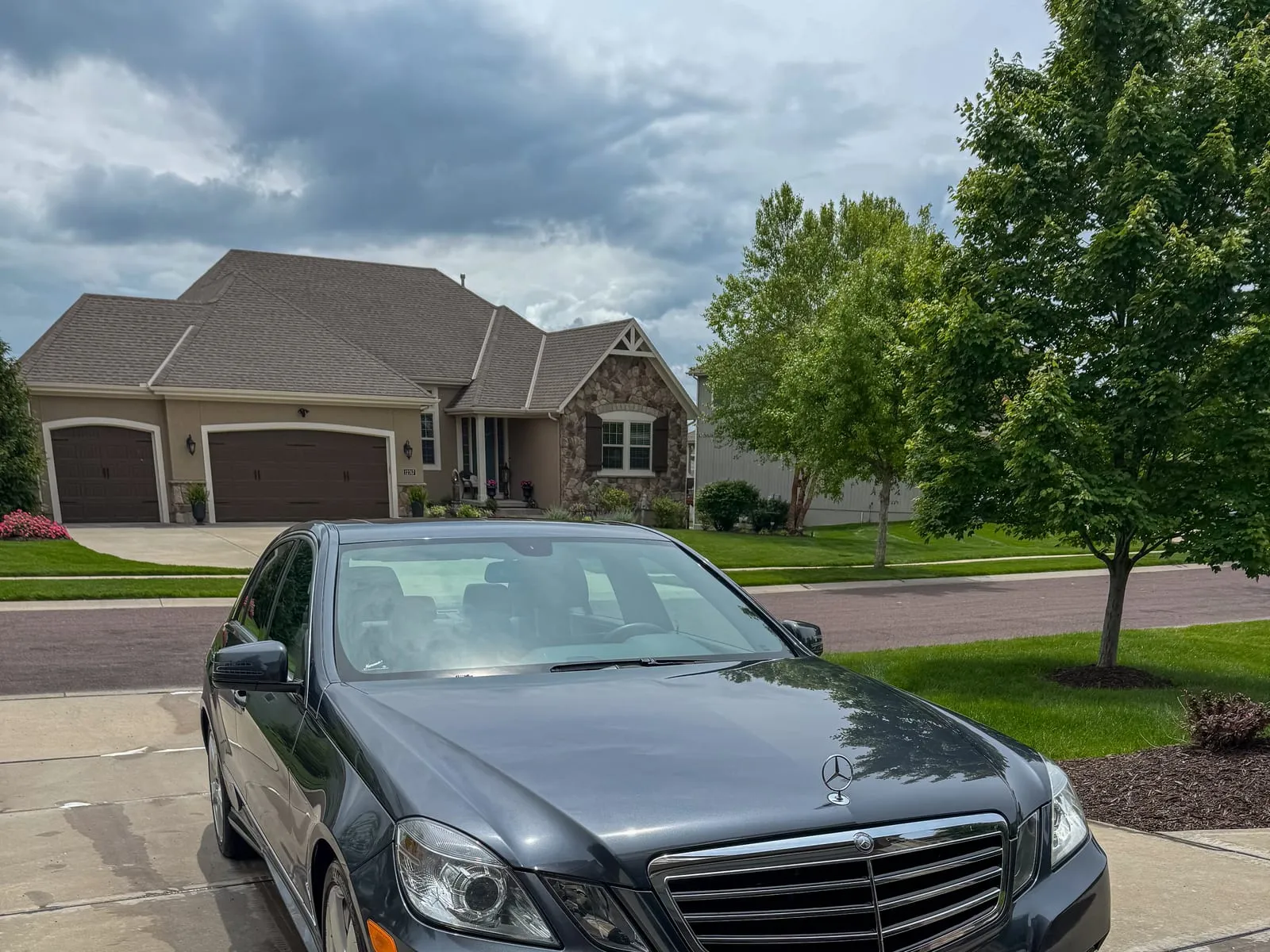 Black Mercedes-Benz S-Class head-on in a driveway, grille and lower bumper cleaned